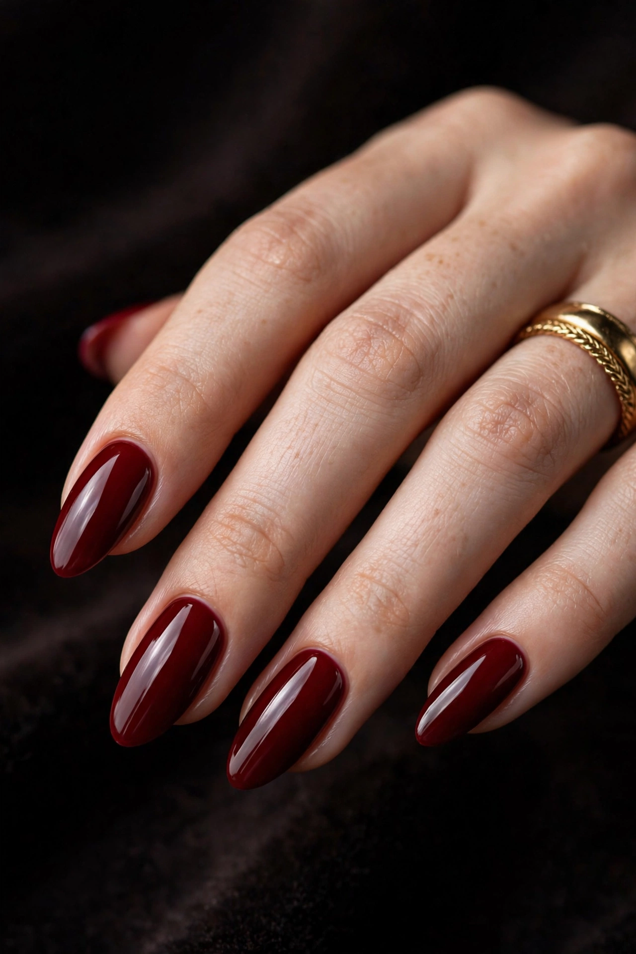 Deep red almond nails glossy manicure