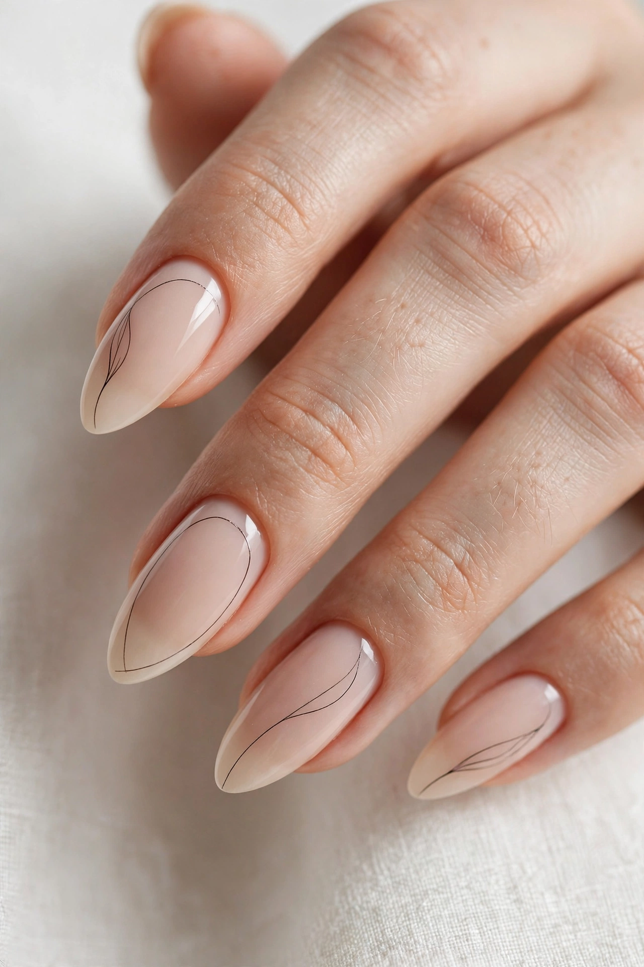 Minimal line art on almond nails delicate design